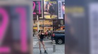 Kirra Collins in Times Square pointing to her billboard